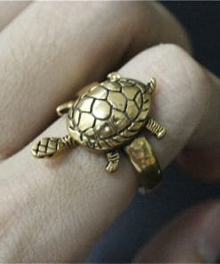 bague tortue dorée portée au doigt